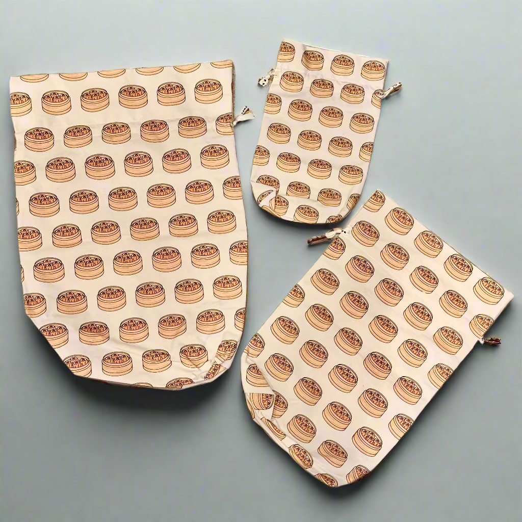 Three sizes of reusable cotton gift bags with illustrated dim sum basket print.