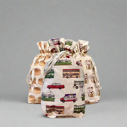 Three reusable drawstring gift bags with lucky cat, dim sum and Hong Kong transport patterns.