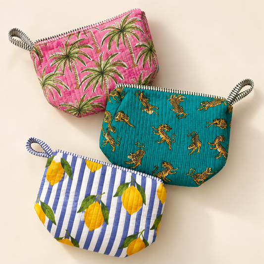 Quilted cotton travel organiser bags in pink palm, teal tiger and blue lemon prints on a warm ivory background